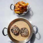 Peppered steak in a creamy sauce with a copper pot of fries at Matsuhisa Saint-Tropez