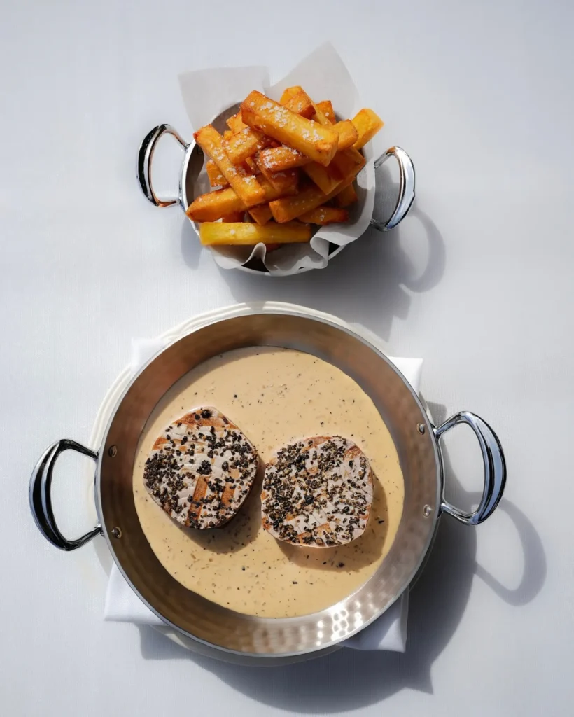 Peppered steak in a creamy sauce with a copper pot of fries at Matsuhisa Saint-Tropez