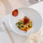Tempura dish topped with chili threads and jalapeño in a white bowl at Matsuhisa Saint-Tropez