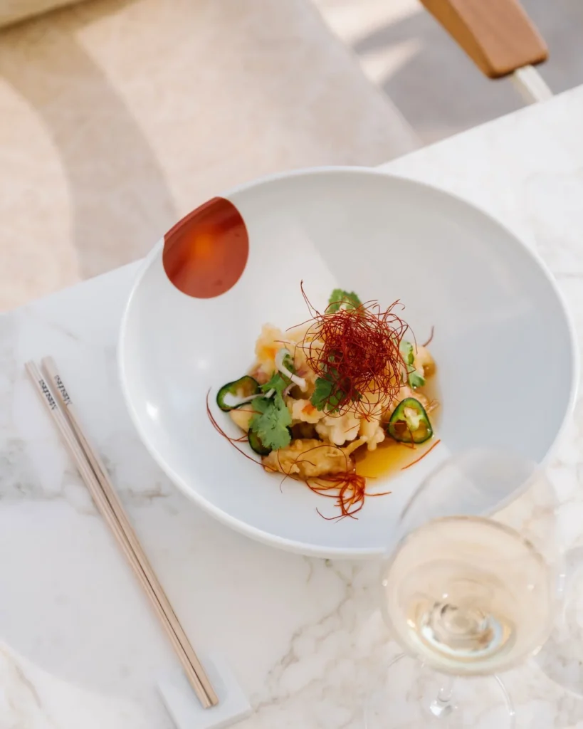 Tempura dish topped with chili threads and jalapeño in a white bowl at Matsuhisa Saint-Tropez