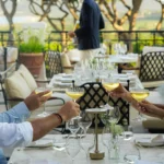 Guests toasting with coupes of champagne at a terrace table at Matsuhisa Saint-Tropez