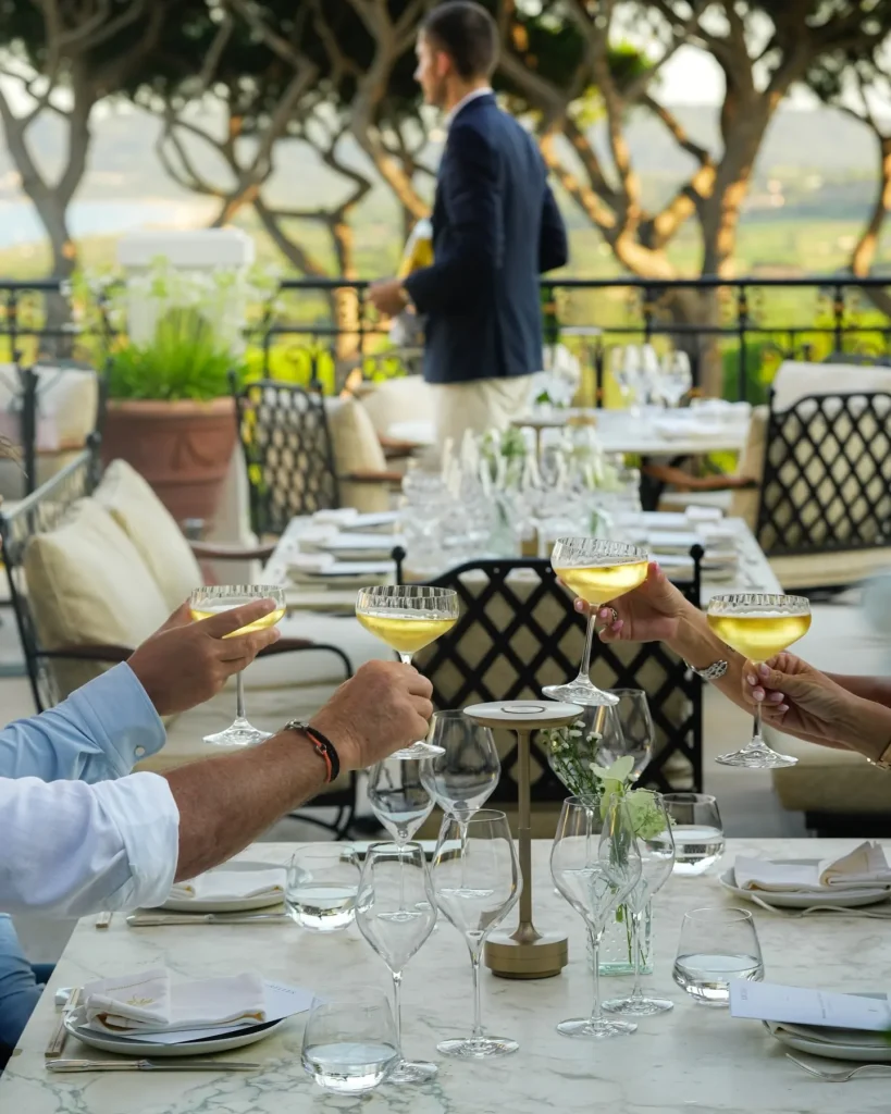 Guests toasting with coupes of champagne at a terrace table at Matsuhisa Saint-Tropez
