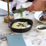 Gloved server shaving black truffle over mashed potato tableside at Matsuhisa Saint-Tropez