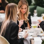Guest dining over cocktails amid greenery and fairy lights at Monsieur Bleu Paris