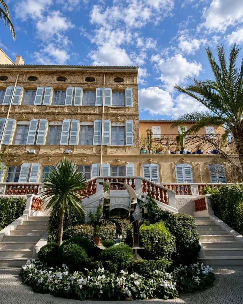 Mirrored Dior sculpture in the garden below the shuttered facade at Monsieur Dior des Lices Saint-Tropez by Mauro Colagreco