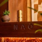NAŌ Saint-Tropez branded signage on wood panelling at the entrance