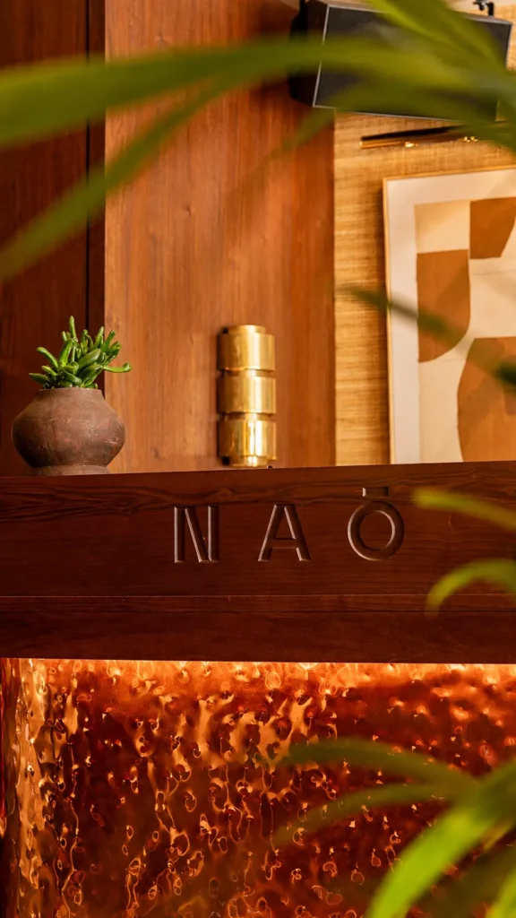 NAŌ Saint-Tropez branded signage on wood panelling at the entrance