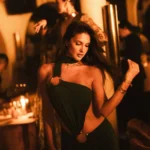 Guest in an evening dress at NAŌ Saint-Tropez during a candlelit party