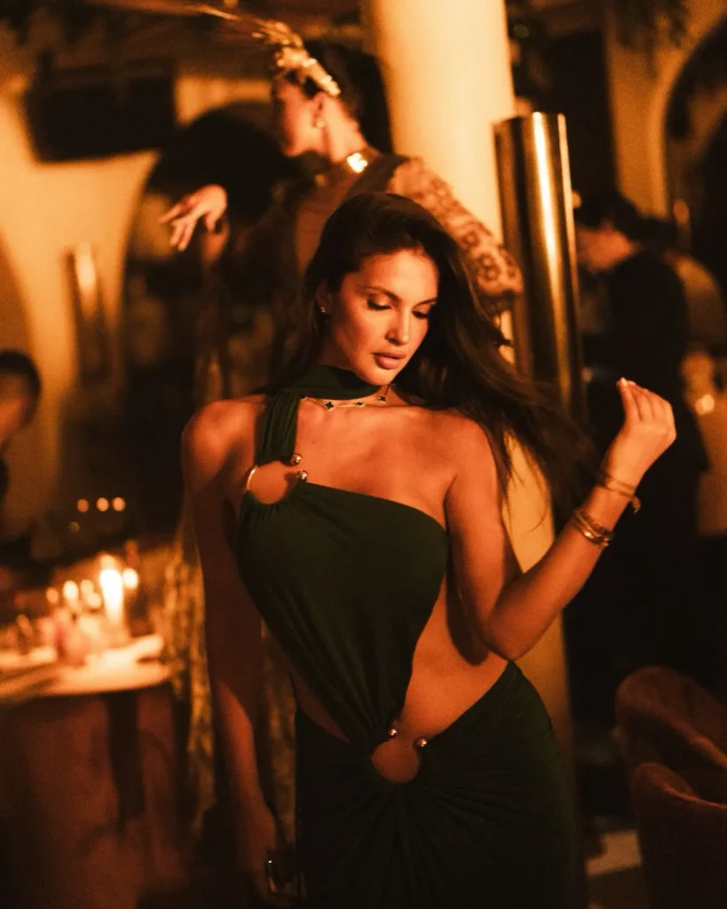 Guest in an evening dress at NAŌ Saint-Tropez during a candlelit party