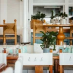 Wooden tables with rush-seat chairs and turquoise accents in the restaurant at Nikki Beach Saint Barth