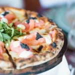 Wood-fired pizza topped with smoked salmon, cream and caviar at Nikki Beach Saint Barth