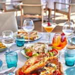 Lobster pasta in a wooden bowl with a truffle salad and drinks at Plage La Serena Ramatuelle Saint-Tropez