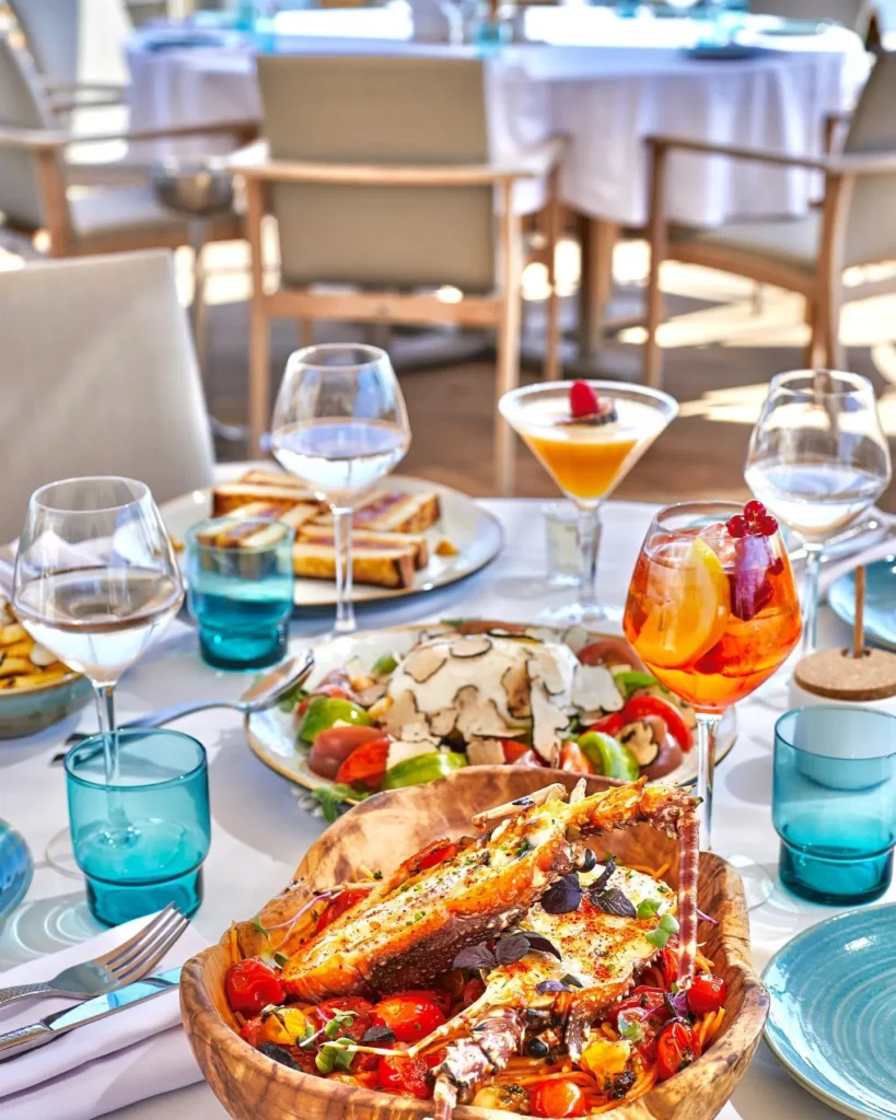 Lobster pasta in a wooden bowl with a truffle salad and drinks at Plage La Serena Ramatuelle Saint-Tropez