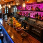 Back bar with fruit bowls and colourfully lit spirit bottles at Restaurante El Cuerno Palma