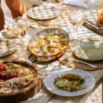 Truffle pasta, grilled fish and sides shared across a wooden table at Shellona Saint-Tropez