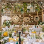 Dining area with woven wall mirrors and hanging plants at Shellona Saint-Tropez