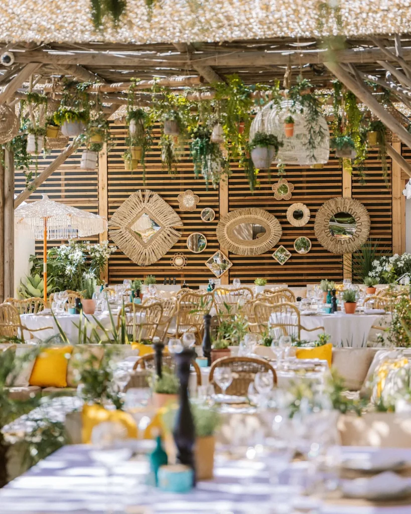 Dining area with woven wall mirrors and hanging plants at Shellona Saint-Tropez