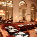 Elegant dining room with tall arched windows at Siena Paris