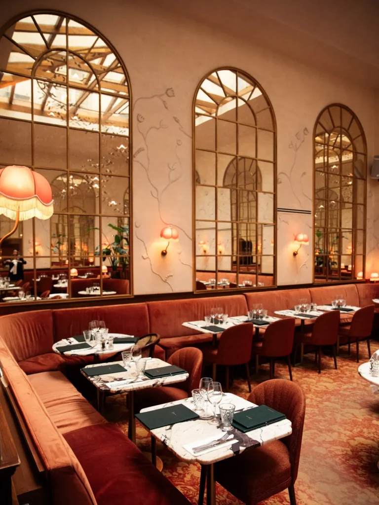 Elegant dining room with tall arched windows at Siena Paris