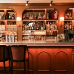 Classic cocktail bar with illuminated shelves at Siena Paris