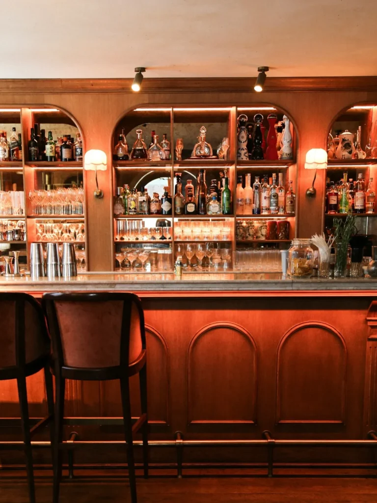 Classic cocktail bar with illuminated shelves at Siena Paris