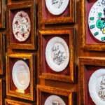 Collection of decorative ceramic plates displayed on the wall at Siena Paris