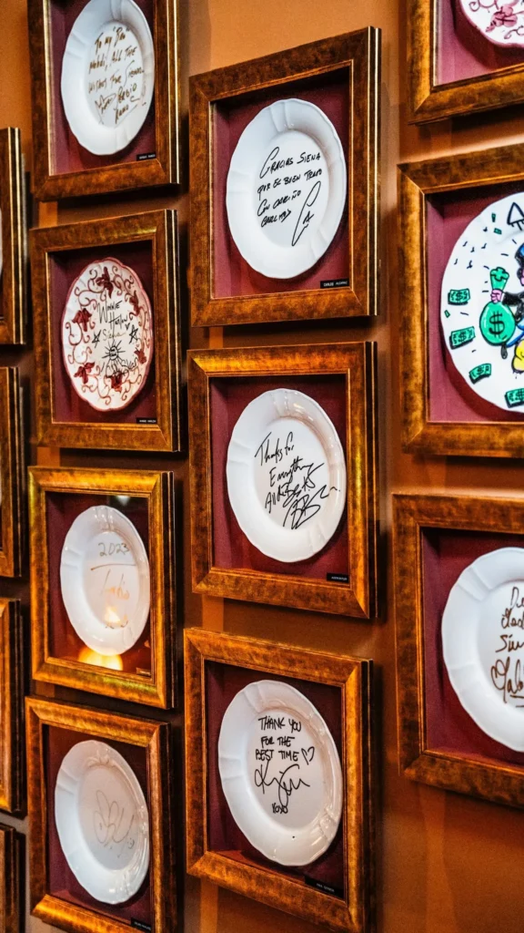 Collection of decorative ceramic plates displayed on the wall at Siena Paris