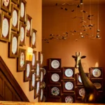 Decorative wall filled with ceramic plates inside Siena Paris