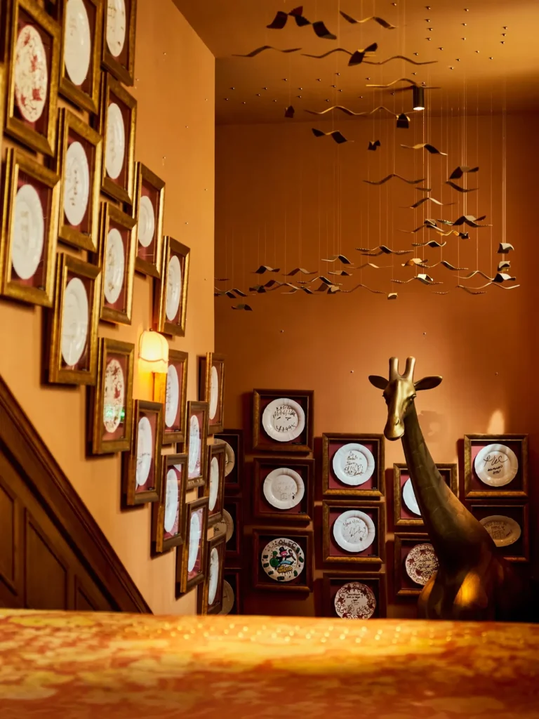 Decorative wall filled with ceramic plates inside Siena Paris
