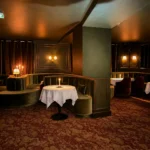 Elegant dining room with warm lighting and intimate seating at Siena Paris
