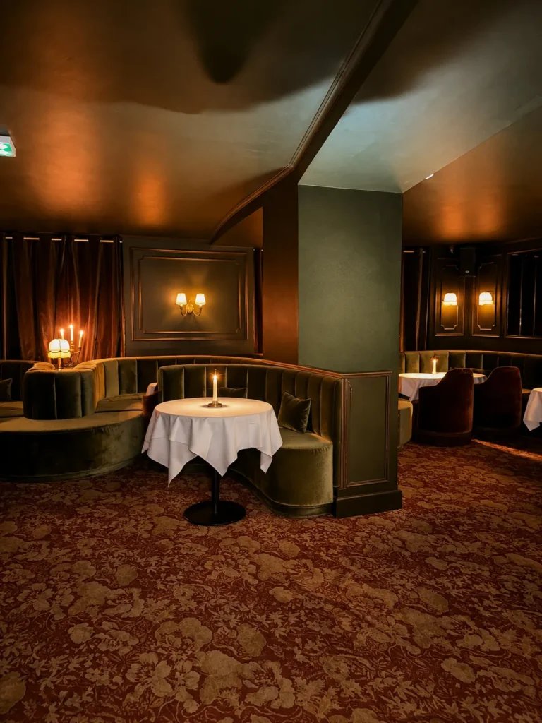 Elegant dining room with warm lighting and intimate seating at Siena Paris