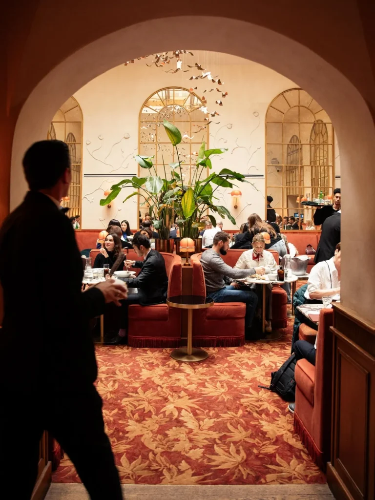Guests dining in the elegant interior of Siena Paris restaurant