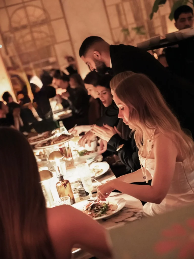 Guests enjoying an evening dining experience at Siena Paris