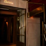 Elegant entrance to Siena Paris restaurant with warm ambient lighting