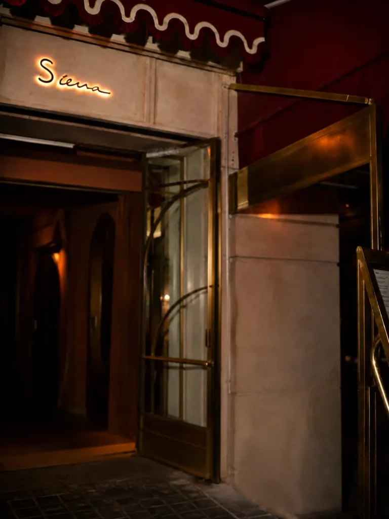 Elegant entrance to Siena Paris restaurant with warm ambient lighting