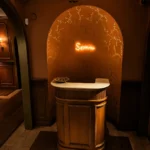 Warmly lit entrance interior with Siena Paris signage