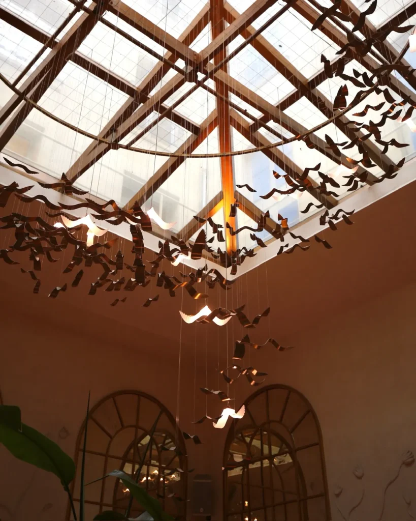 Decorative glass ceiling and hanging ornaments inside Siena Paris
