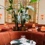 Elegant red upholstered seating and dining area at Siena Paris