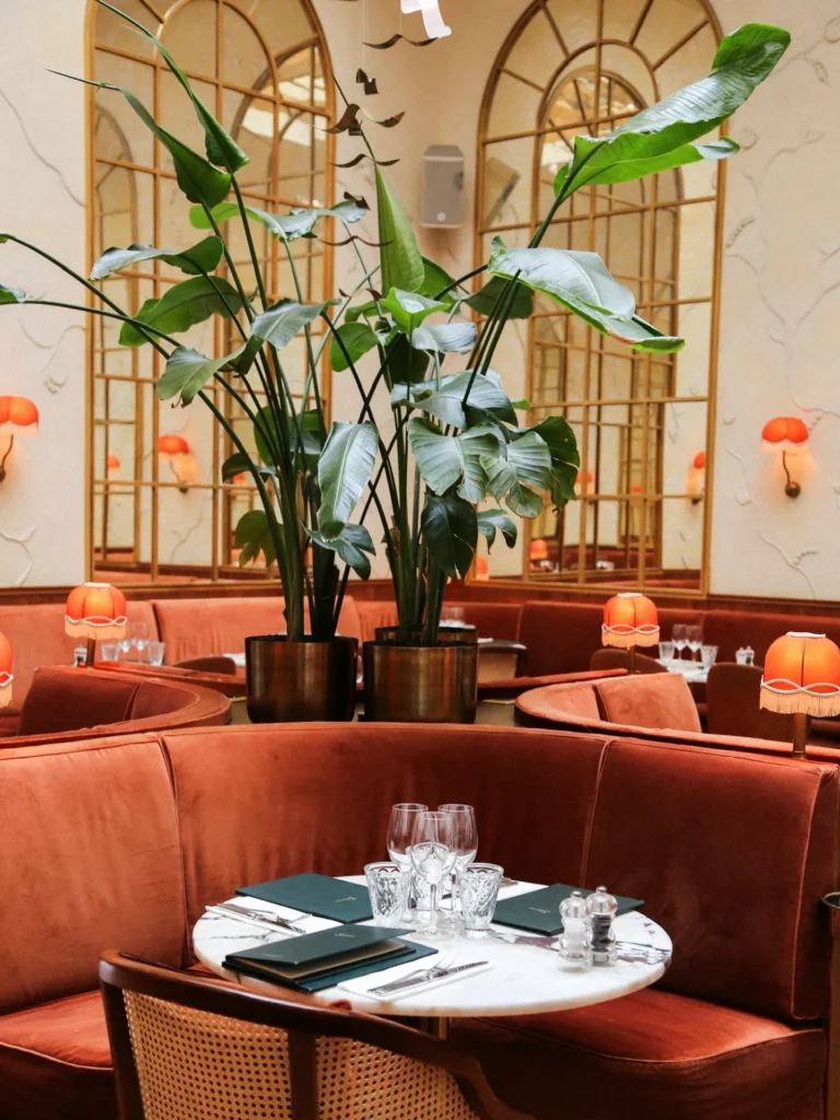 Elegant red upholstered seating and dining area at Siena Paris