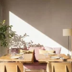 Sunlit corner banquette with striped cushions and a lemon tree beside a set table at SPOT Palma De Mallorca