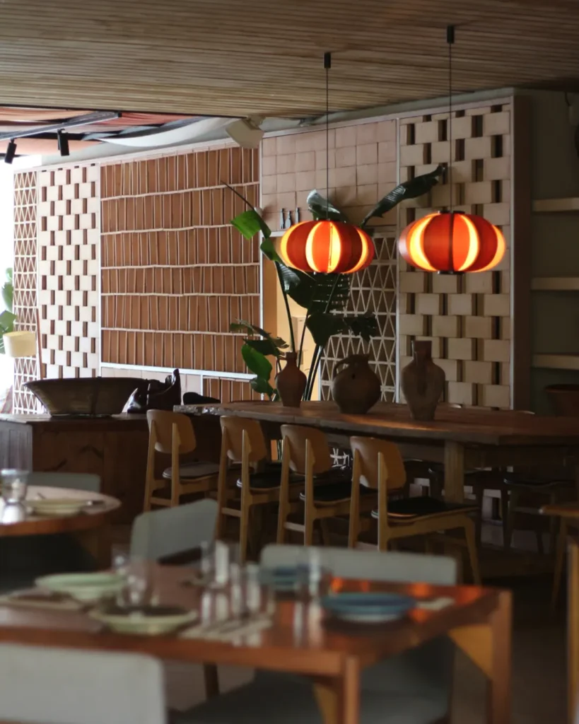 Dining room with orange melon lanterns, earthenware jugs and a brick lattice screen at SPOT Palma De Mallorca