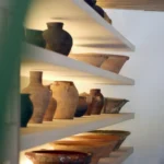 White shelves lined with terracotta jugs and glazed bowls at SPOT Palma De Mallorca