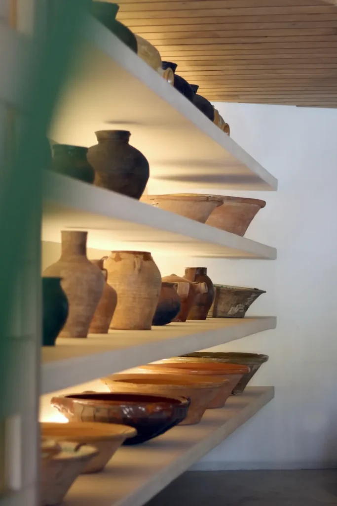 White shelves lined with terracotta jugs and glazed bowls at SPOT Palma De Mallorca