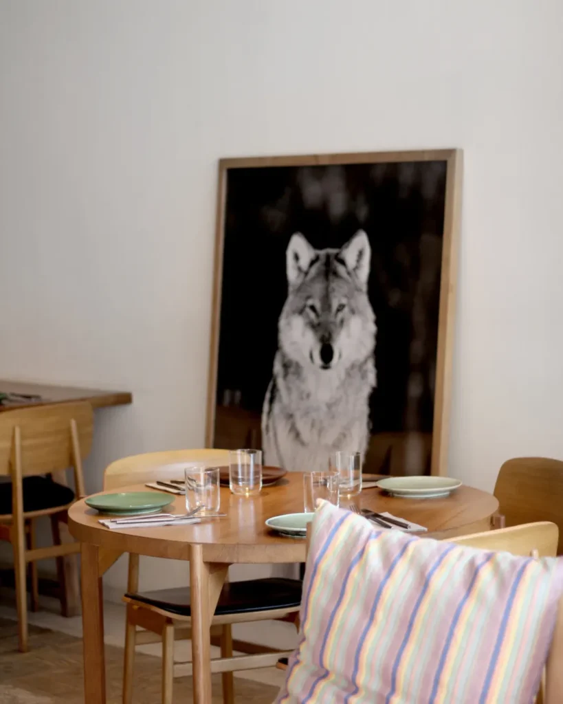 Round table set beneath a large black-and-white wolf photograph at SPOT Palma De Mallorca