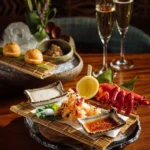 Lobster tempura platter served with dipping sauces and champagne at Zuma Cannes