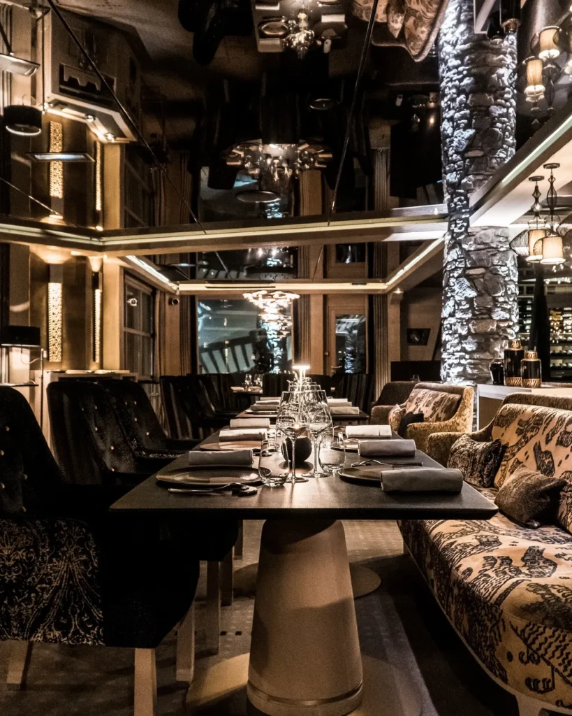 Warm wood and stone restaurant interior at L'Altiplano K2 Palace