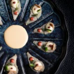 Seafood platter with dipping sauce served at L'Altiplano K2 Palace