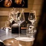 Elegant table setting with wine glasses at L'Altiplano K2 Palace