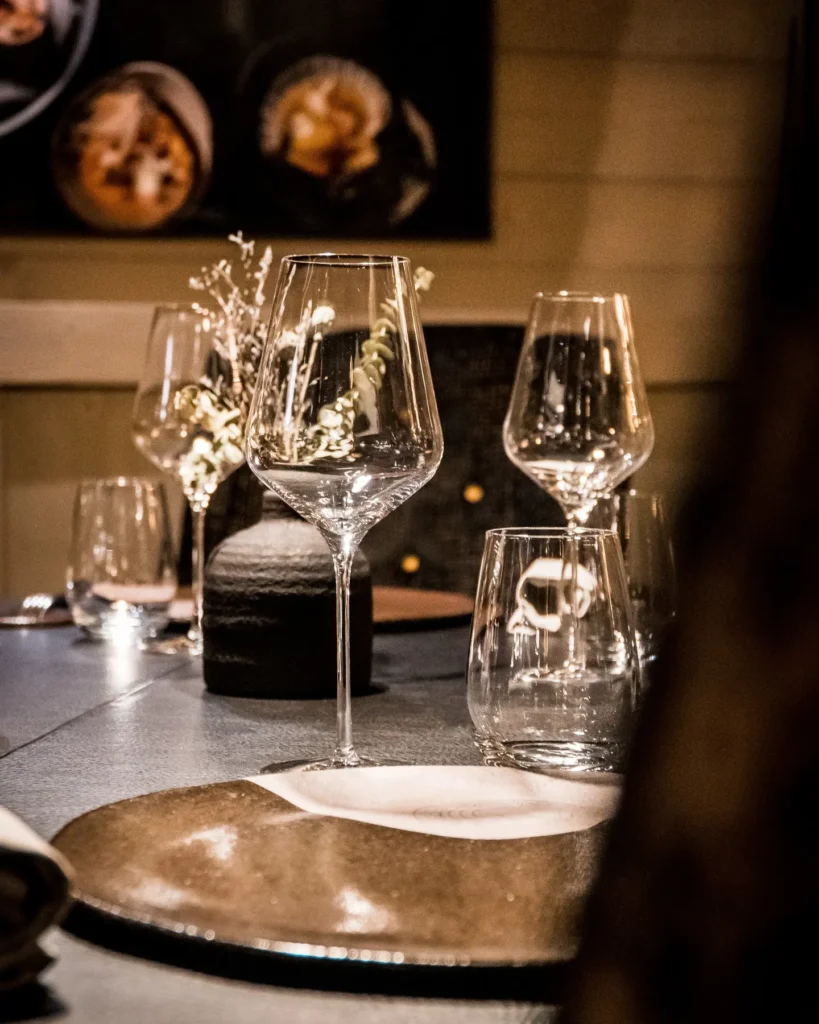 Elegant table setting with wine glasses at L'Altiplano K2 Palace