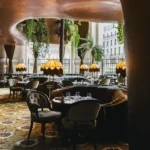 Warmly lit lounge and dining area inside BeauCoCo Paris